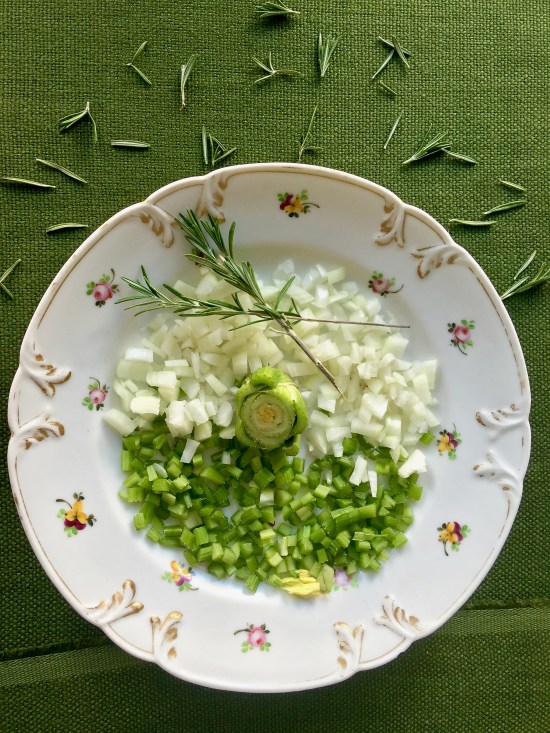 chopped-onions-and-celery-on-green-linen-vertical